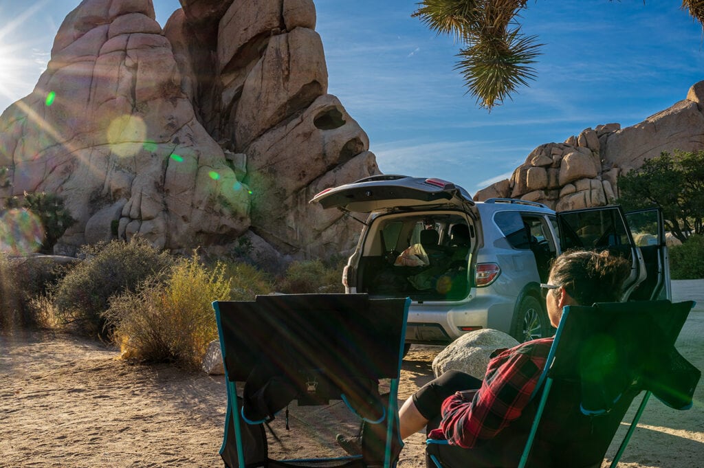 Woman sits in Camping Chair on Joshua Tree National Park Campground