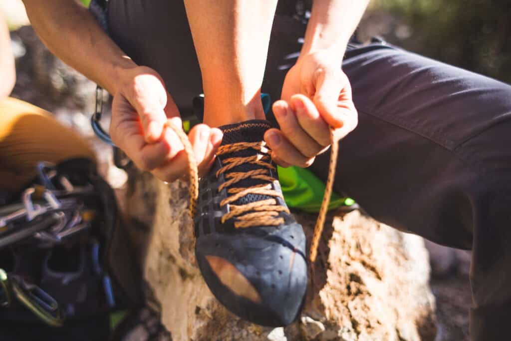 Climber putting on shoes