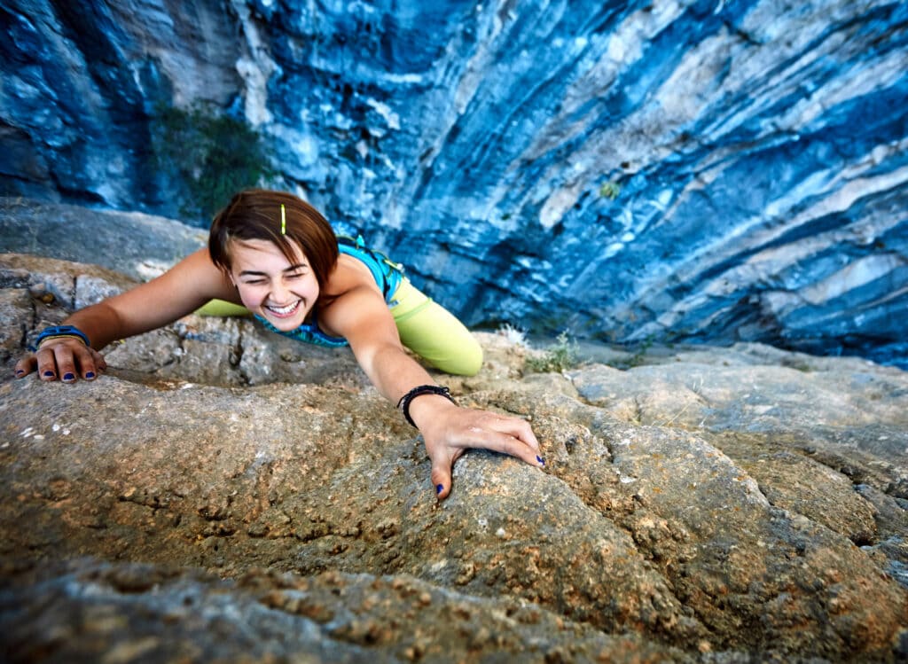 female outdoor climber chalk