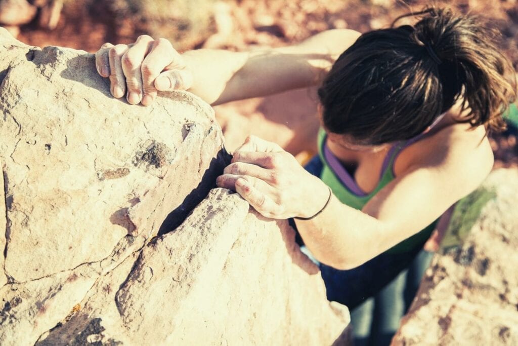 woman climbing on the rock