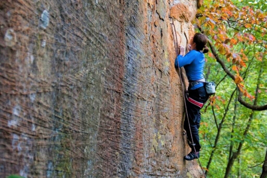 woman lead rock climbing on a guided trip