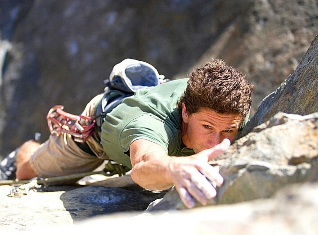 Rock climber grabbing a rock