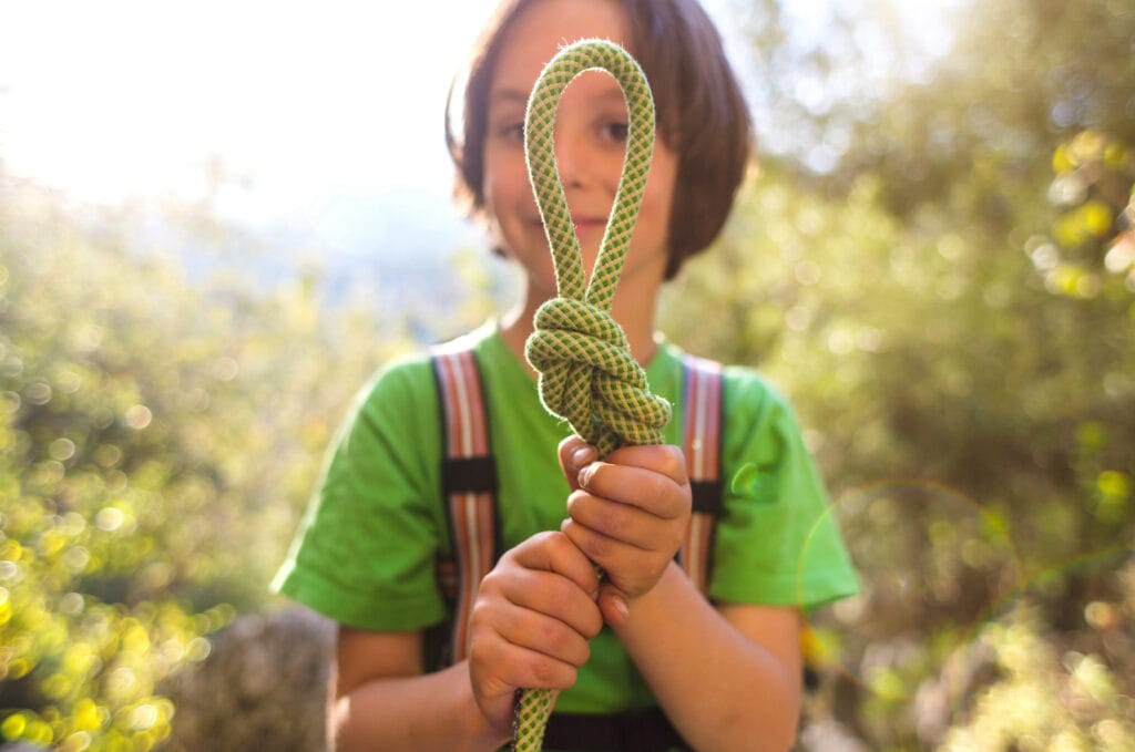 boy climber with figure eight knot for brake rope