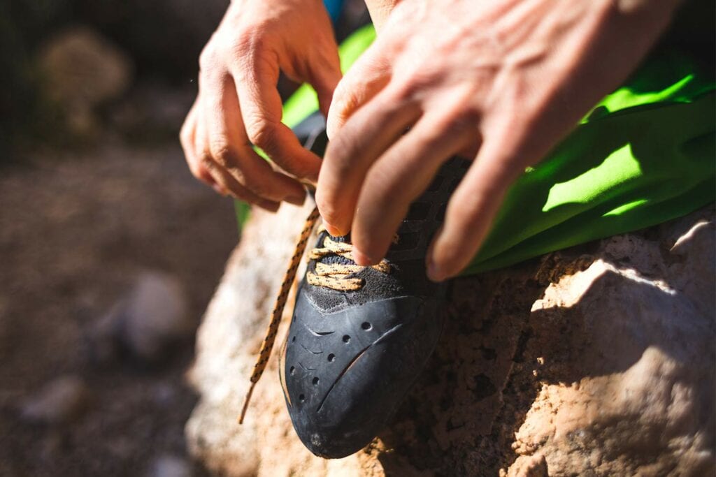 Lacing up to wear shoes for climbing