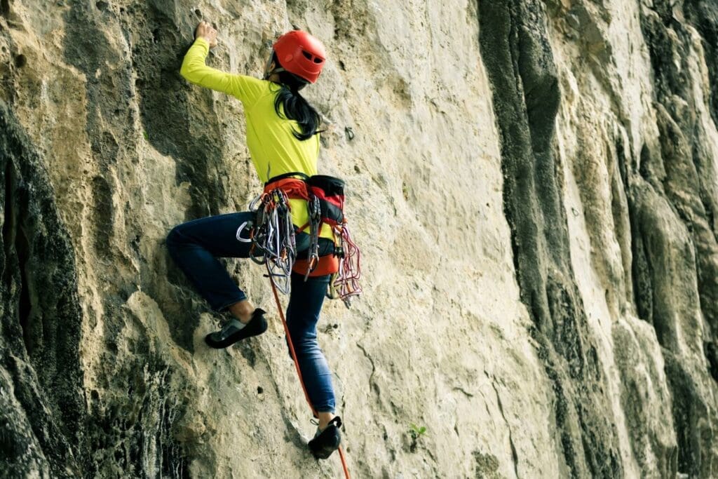 woman trad climbing