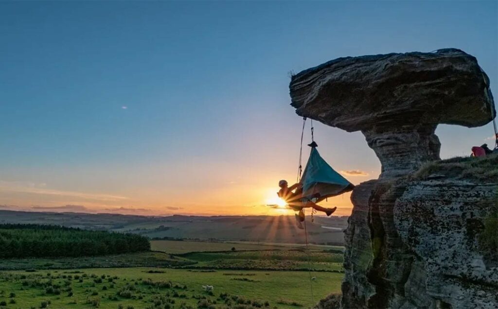 climber sleeping in a D4 portaledge Durango Sewing Solutions on natural ledges
