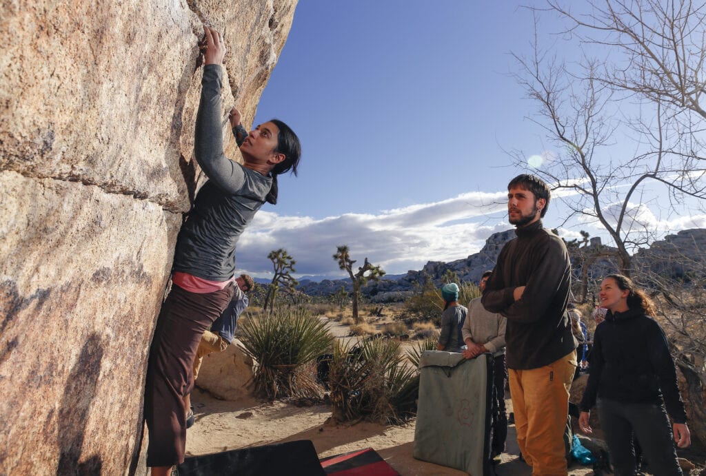 rock climbers bouldering desert with crash pads