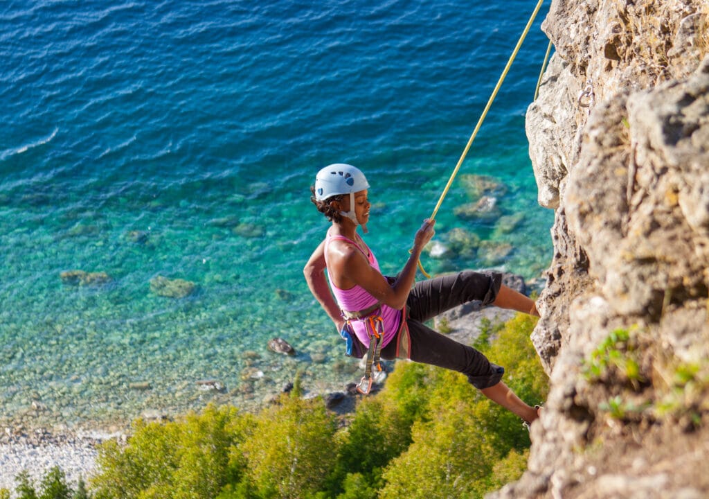 climber practicing climbing techniques on the coast