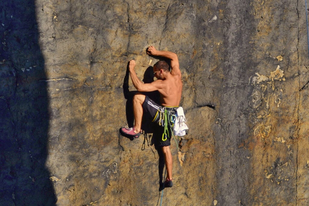 strength rock climbing athlete on climbing route