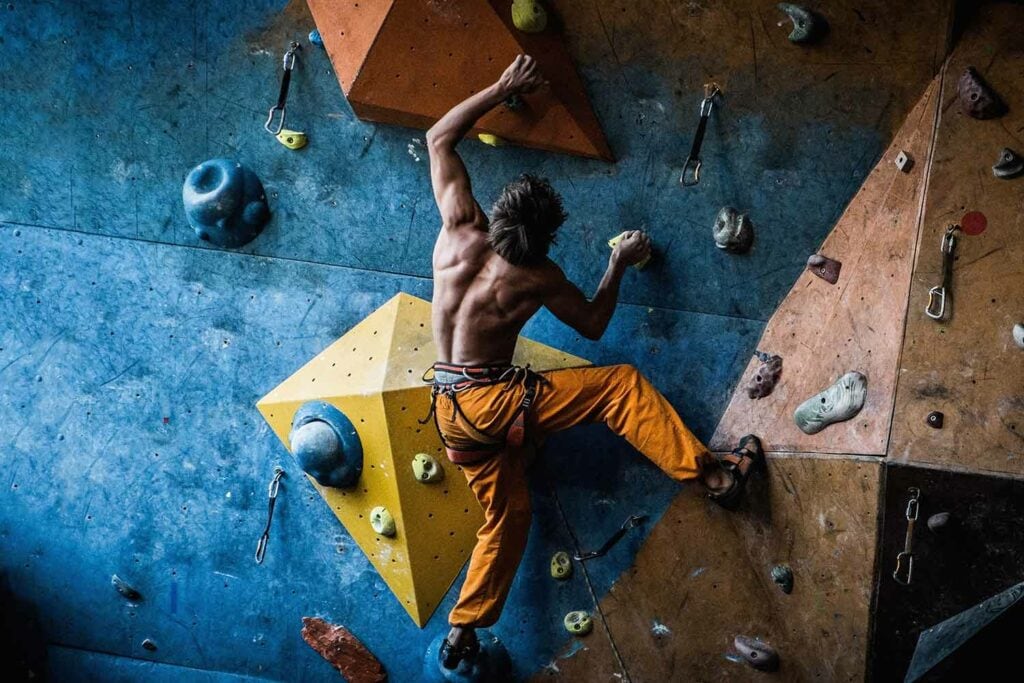 man climbing at indoor gym