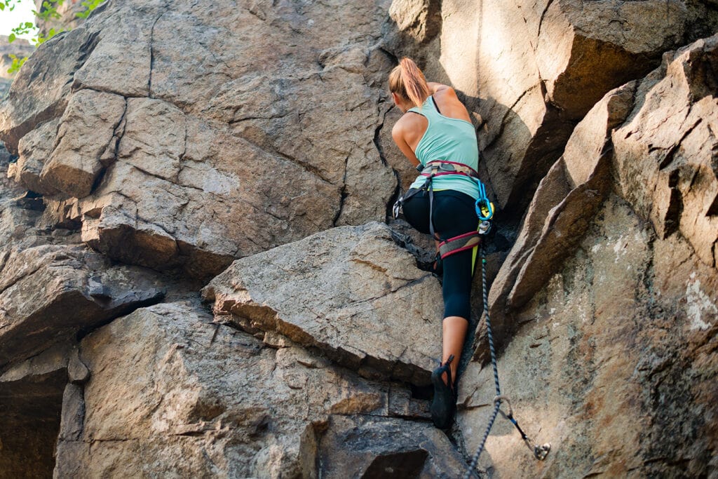 Female climber attempting one of the difficult routes of the area