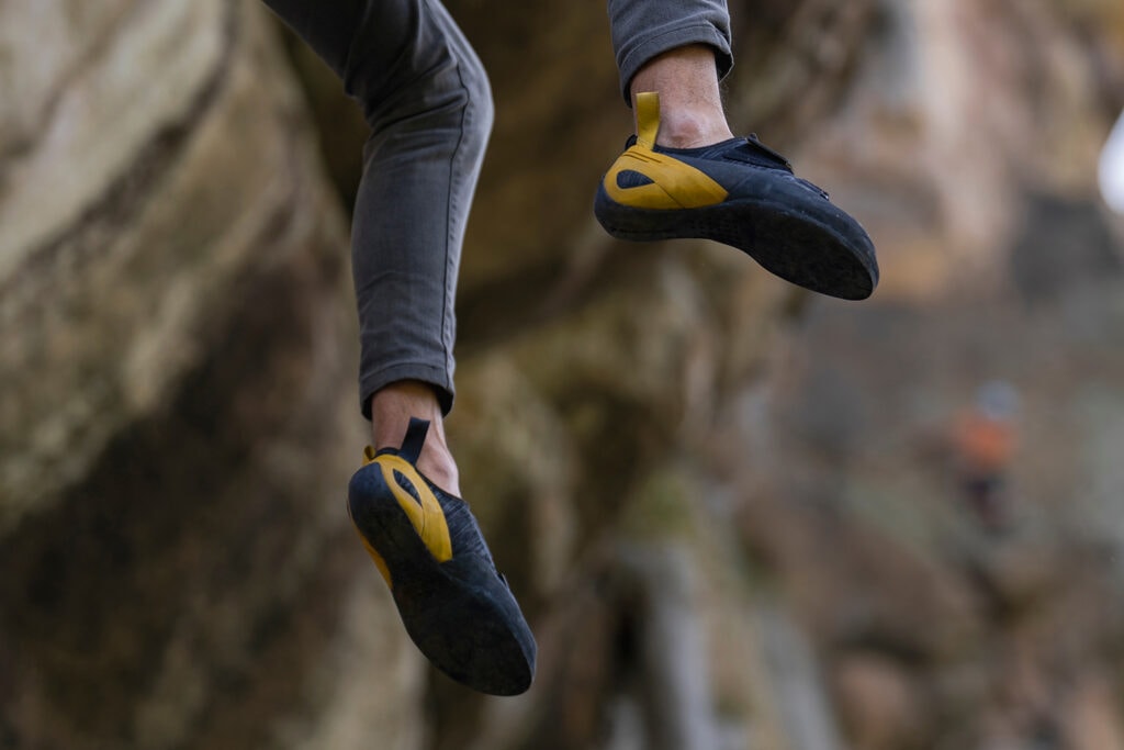Climber in action with view of the heel of a downturned shoe