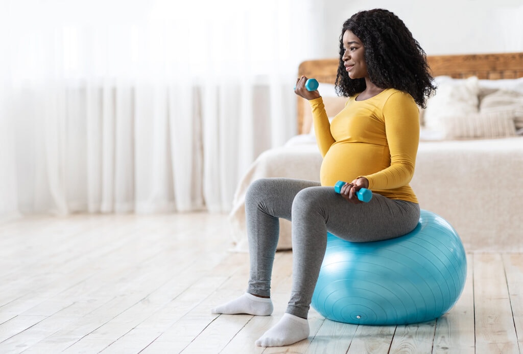woman exercising at home during pregnancy