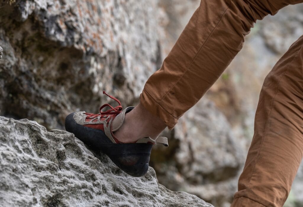 tight shoes can be painful so this climber is wearing comfortable beginner climbing shoe