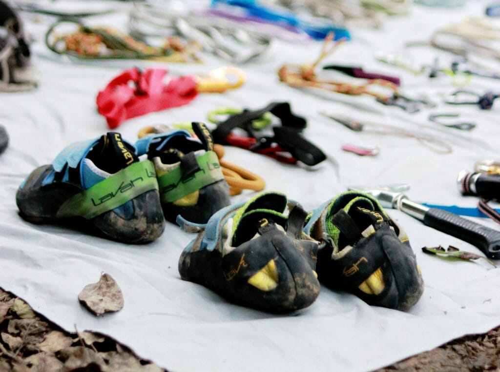 sport climbers with different pairs of velcro climbing shoes for different foot shapes