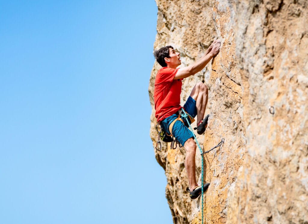 rock climber wearing comfortable climbing shoe and outdoor gear, demonstrating his climbing skills and 