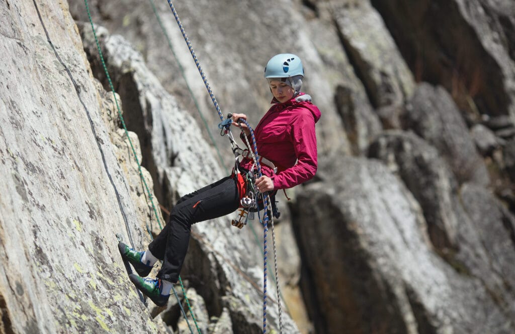 rappelling off big wall (view of the harness with gear)