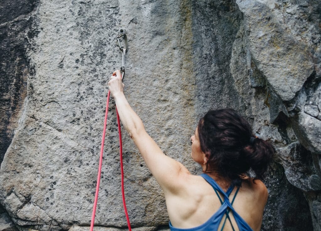 climber practicing clipping on the ground