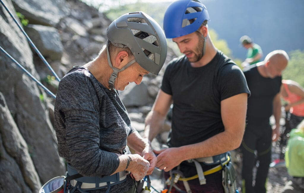 group of climbers with instructor wearing climbing helmets