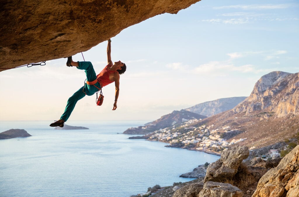 man climbing challenging route
