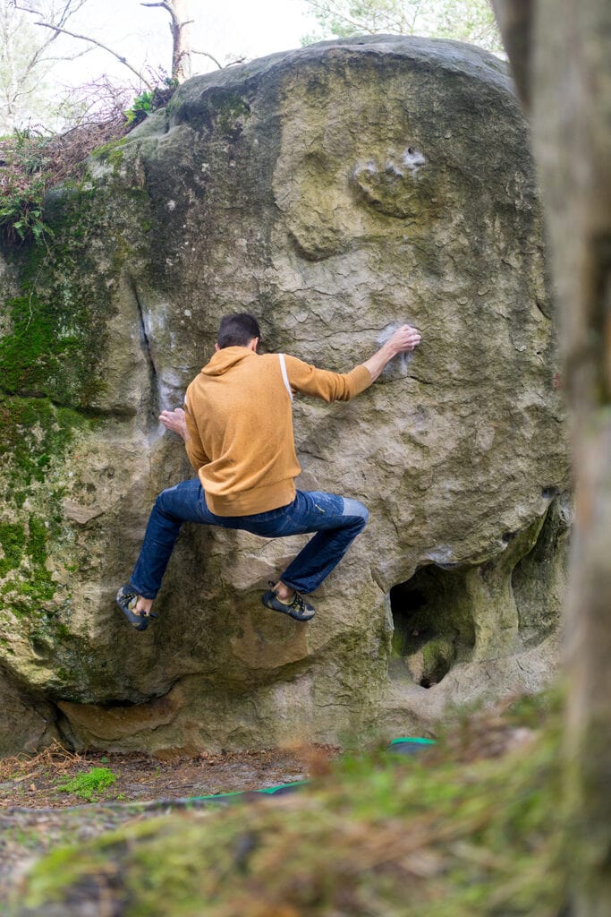 man bouldering in Fontainebleau, France