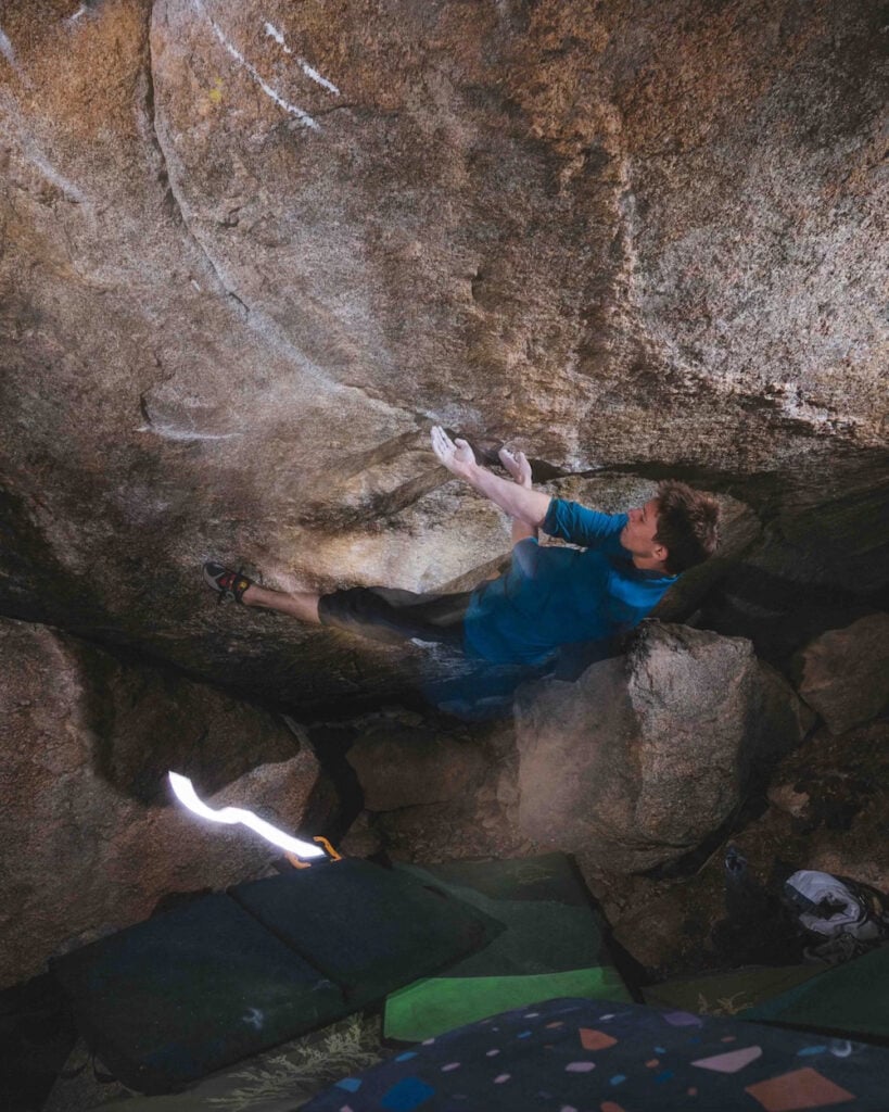Drew Ruana on Maxwell's Demon v14 first ascent, end of the route