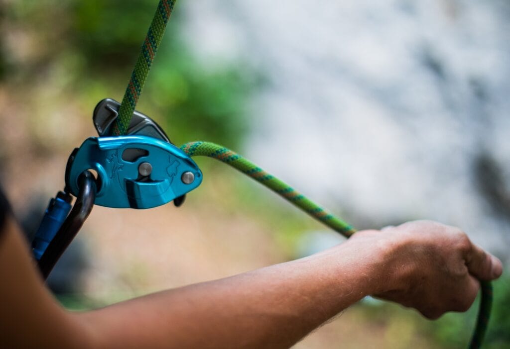 climber with grigri and hand on the brake rope (top belay)