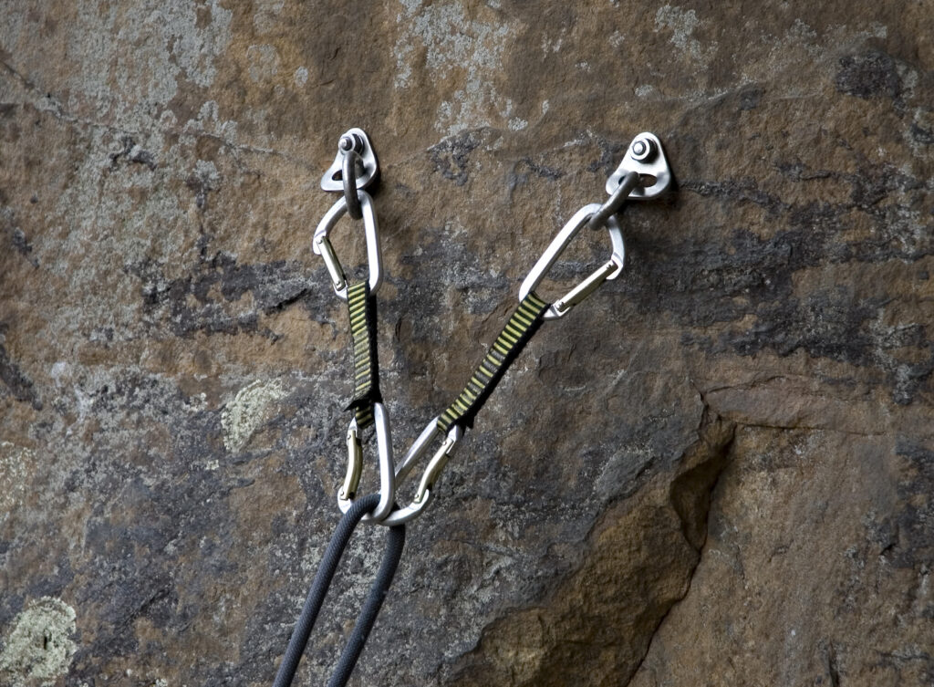 example of bolt anchors with security in case one anchor point fails (top rope anchor setup)