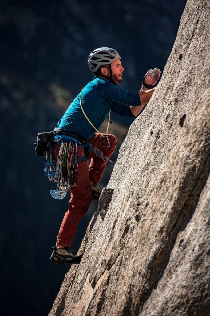 Trad climber with equipment attached to the gear loops of his harness