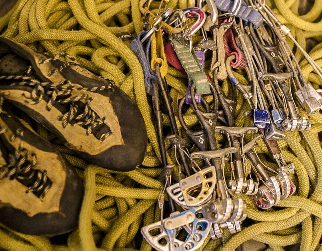 used climbing gear with large cams and rope