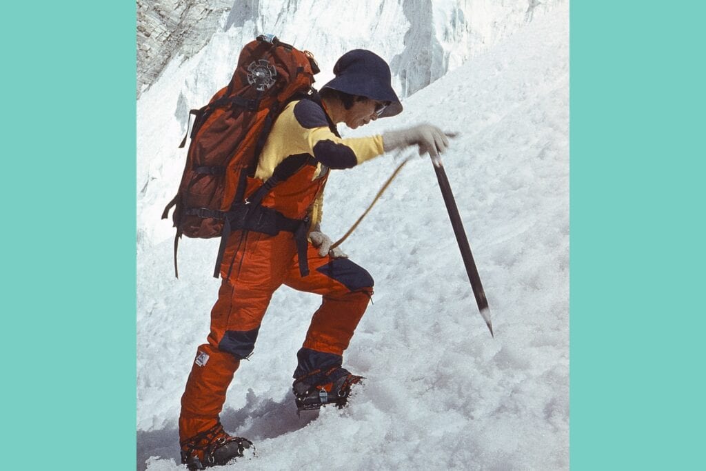 mountaineer Junko Tabei with ice axe and crampons making her way in steep snow