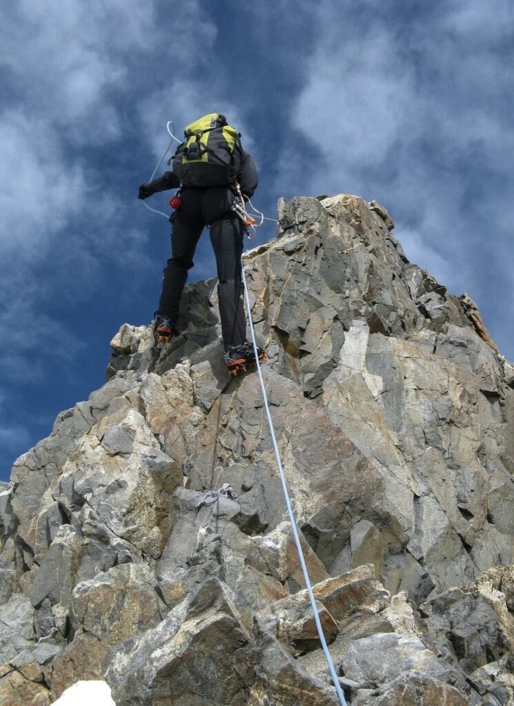 Climber rappelling after summiting a peak