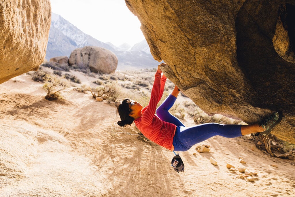 Woman rock climbing, Buttermilk Boulders, Bishop, California, USA