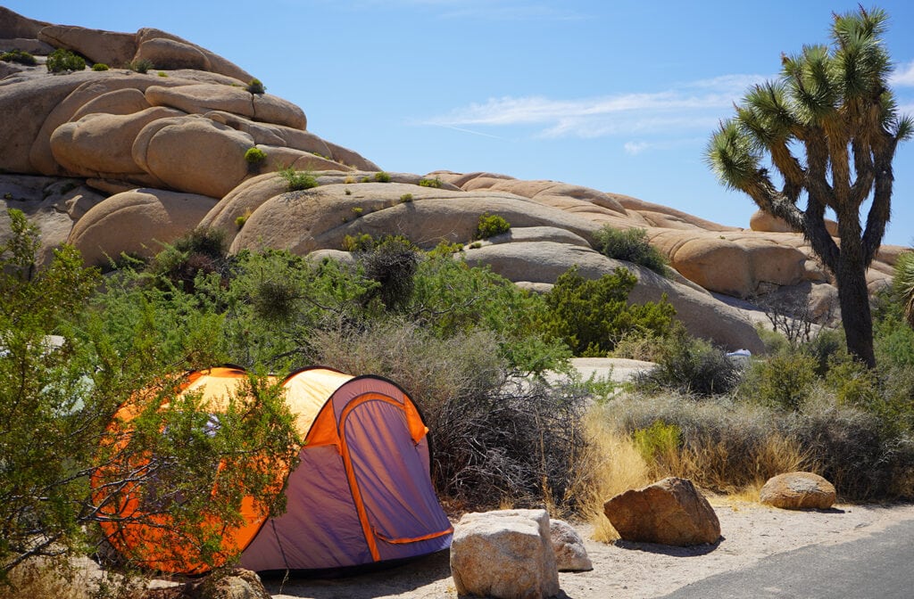 Camping tent near stones formation in Joshua Tree National Park, California, USA
