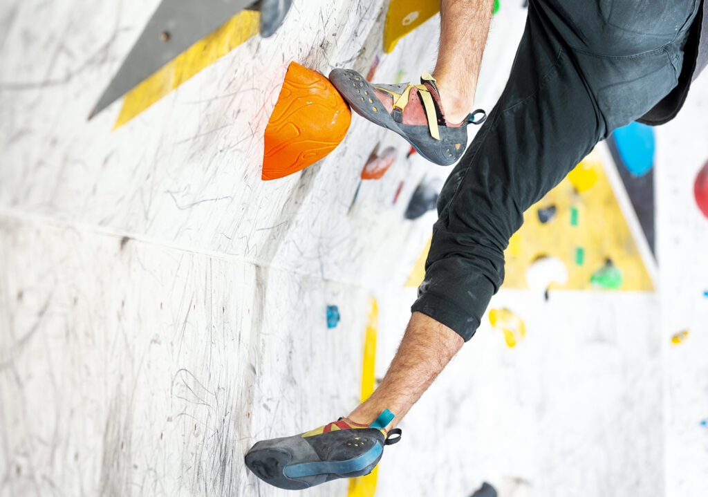 young climber climbing bouldering shoe indoor
