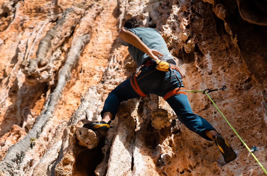 Lead climber outdoor with a used climbing harness
