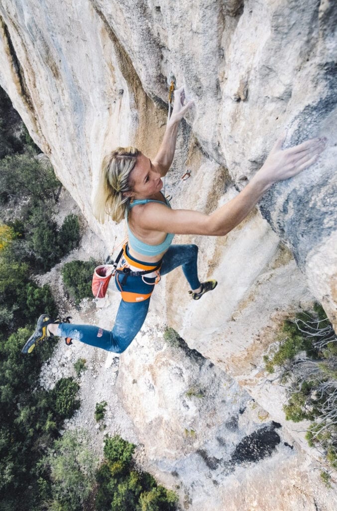 female climber wearing Petzl Sitta harness
