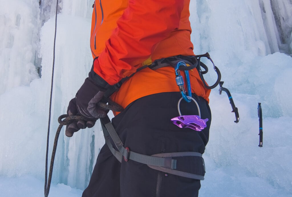 ice climber wearing climbing harness