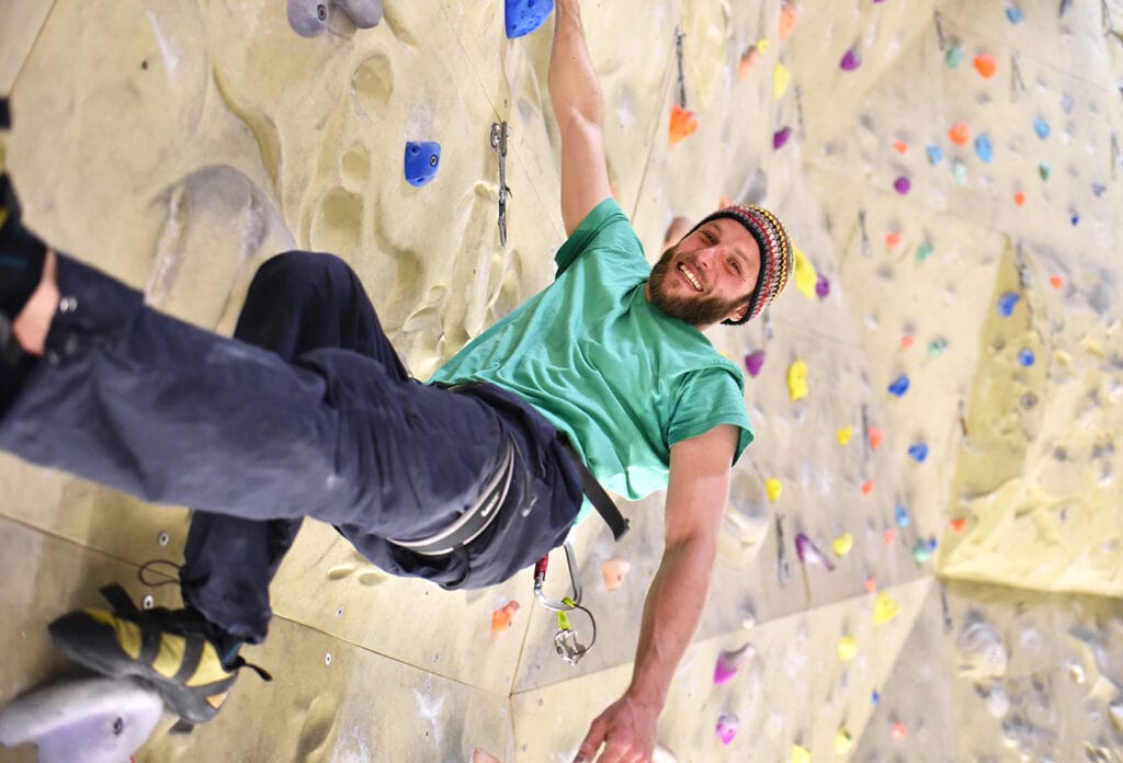 athlete on a climbing wall at one of the city's climbing gyms