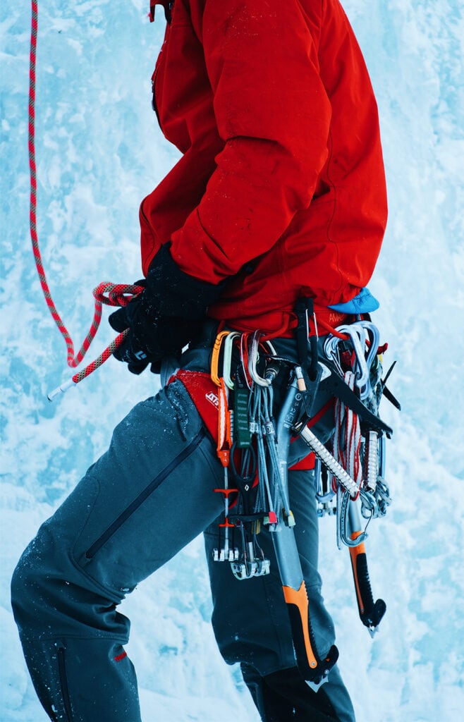 mountain climber ice climbing with equipment