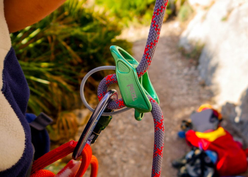 Belayer using a petzl reverso with a locking carabiner