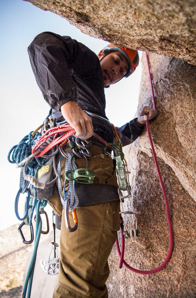 trad climber with difference pieces of equipment including light use carabiners