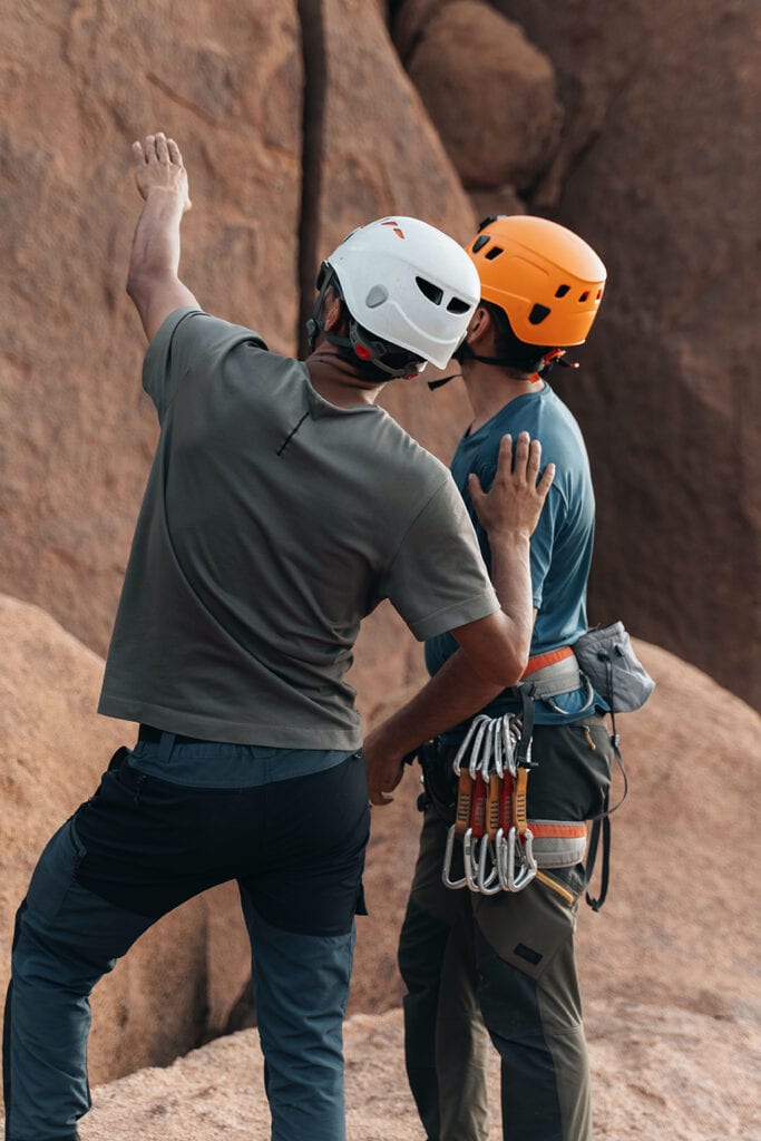 two people discussing a climbing route