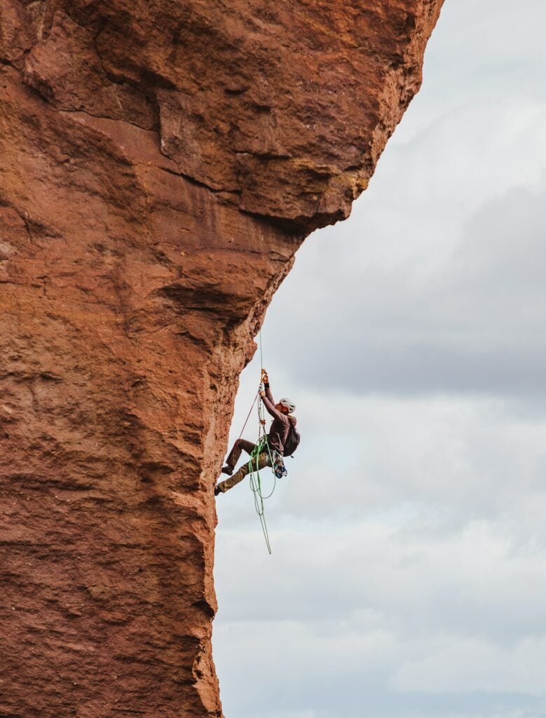 first of two sport climbers rappelling after a multi-pitch ascent