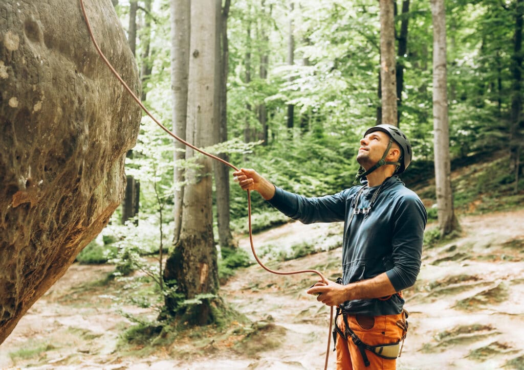 belayer with one hand feeding rope and the breaking hand down for safety