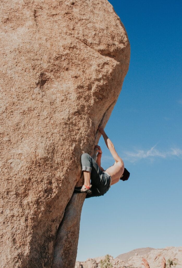 climber on a difficult boulder outdoors