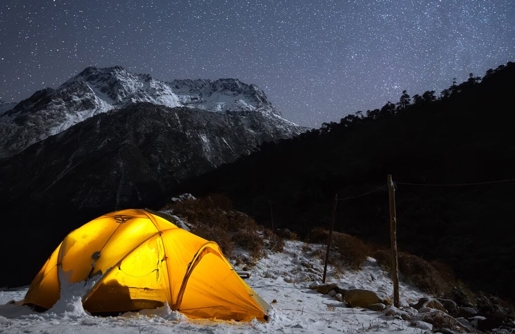 A starry sky high in the mountains and a tent