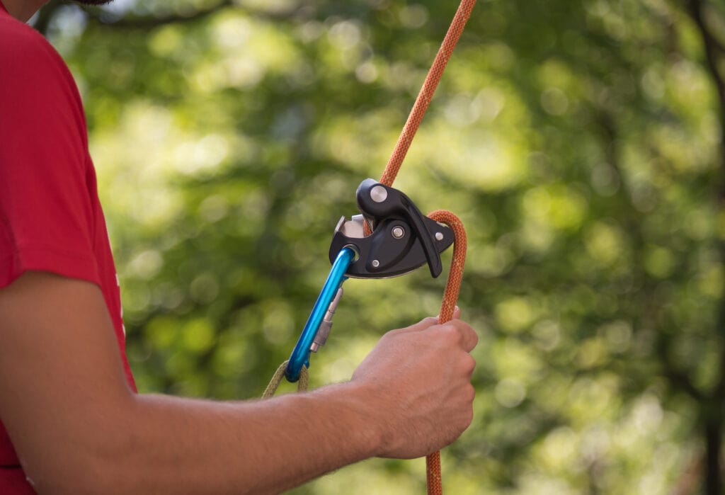 belayer using the grigri with the brake hand down under the device