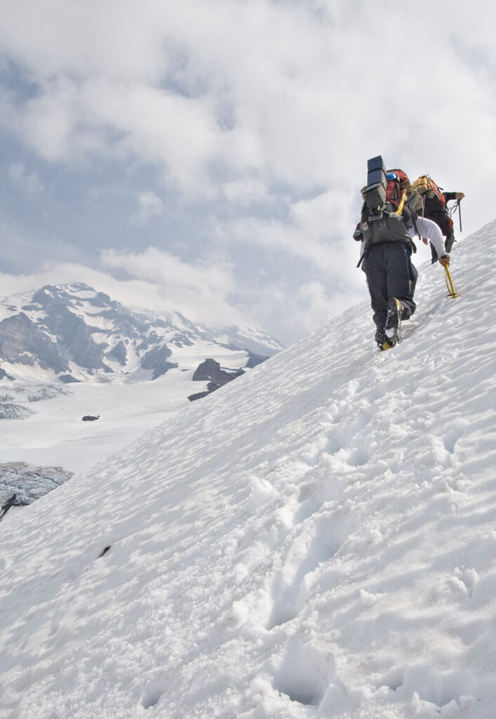 Climbers ascending a snow slope on Mount Rainier's Kautz Glacier.