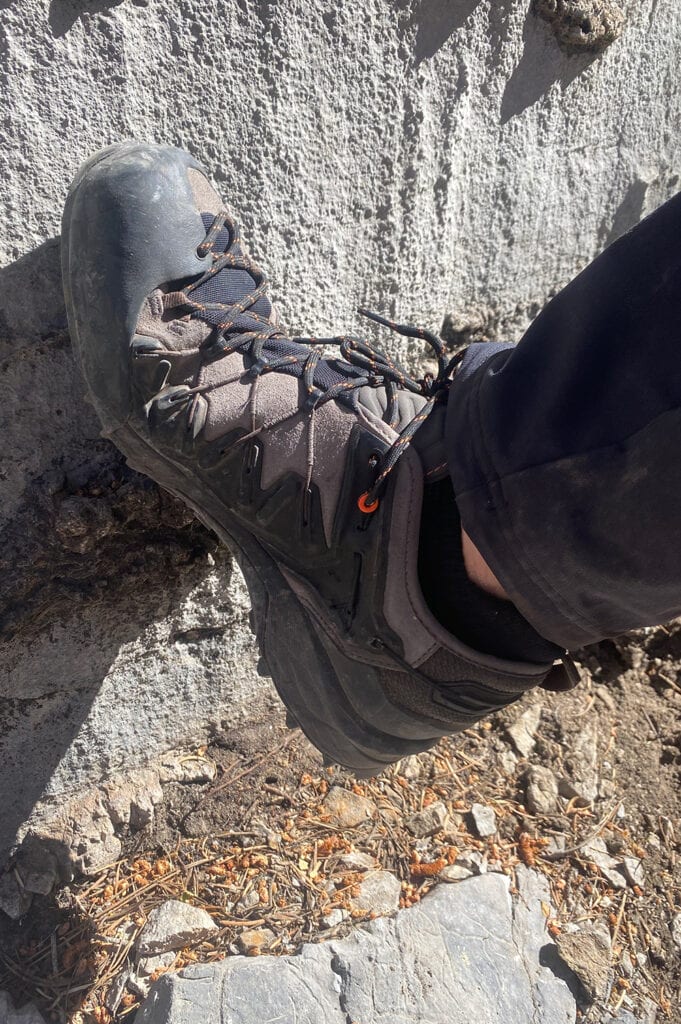 Reviewer showing hiking shoes for technical terrain like muddy trails on approach